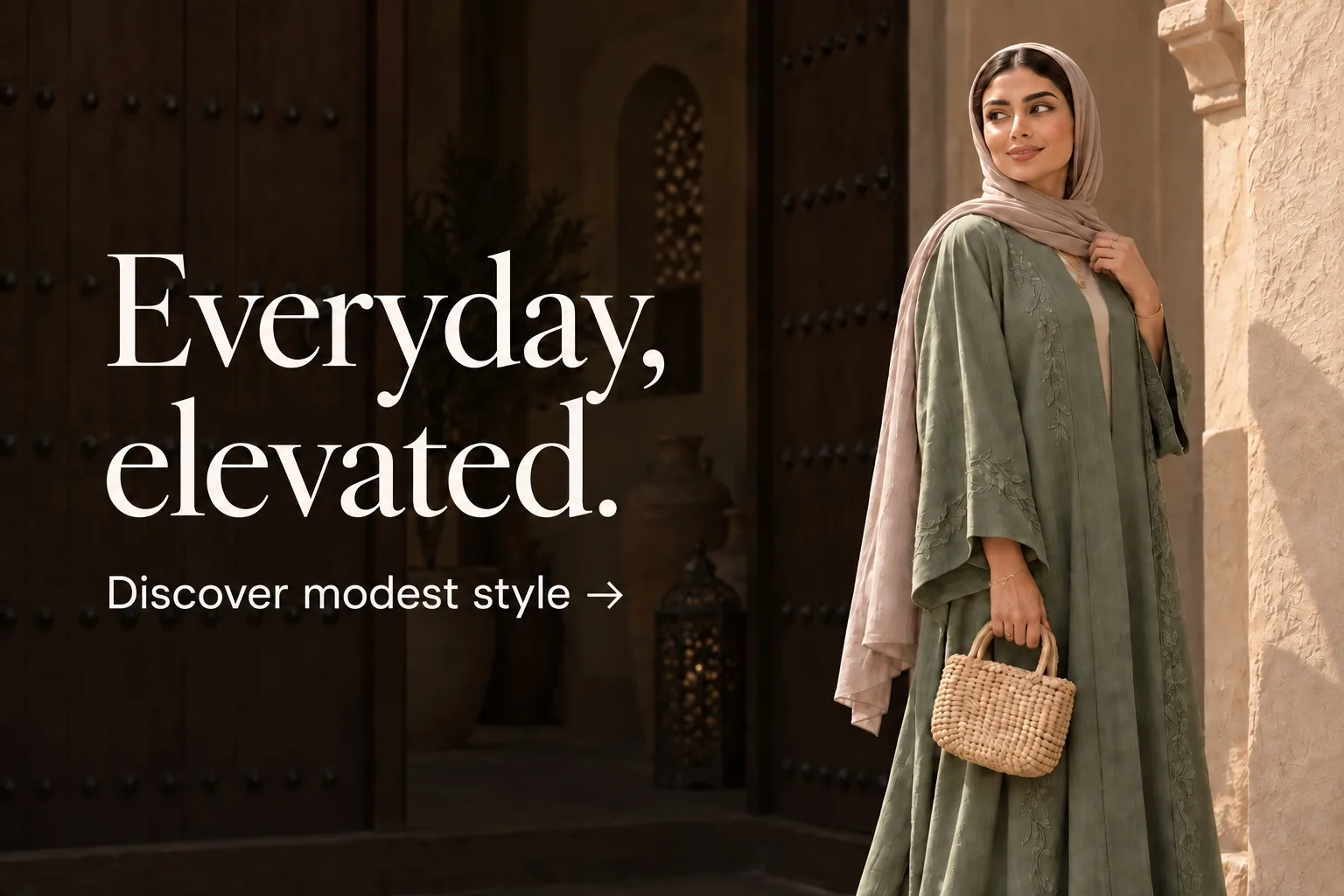 Everyday, elevated. Discover modest style. A model in a sage abaya beside a shaded Emirati doorway.